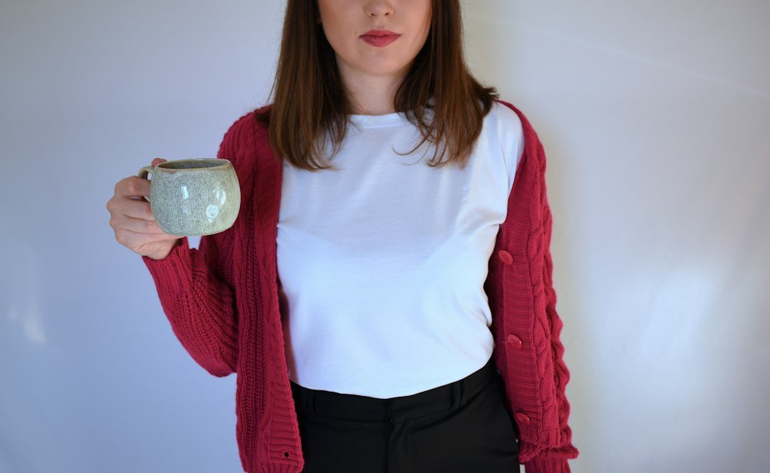 a person holding a silver cup